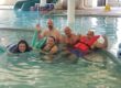 a group of people at action recovery brain injury services enjoy swimming at the ymca